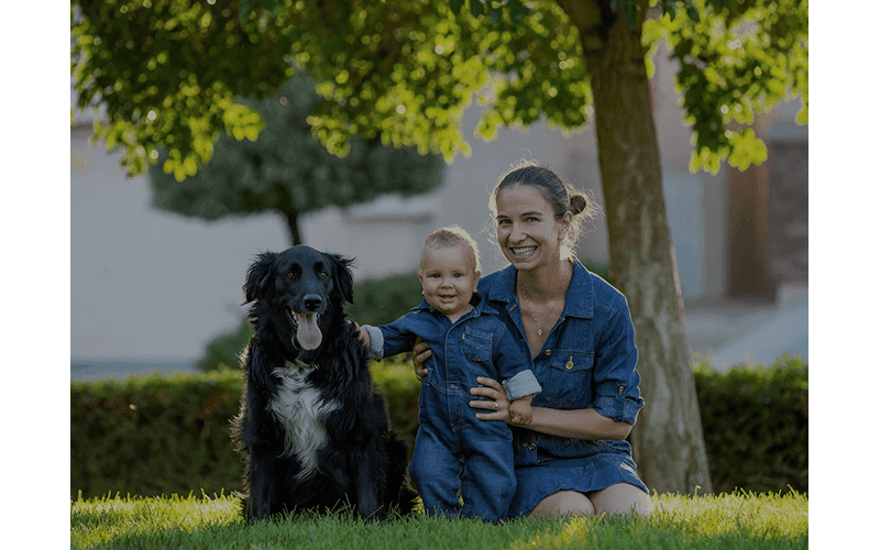 Woman, child, and dog smiling